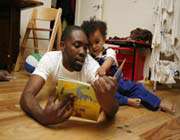father reading book to his baby