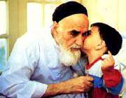 a child kissing imam khomeini 