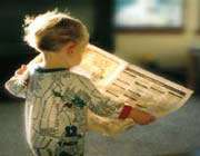 kid reading newspaper
