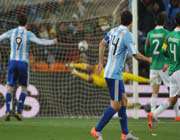 mexico goalkeeper oscar perez (back, r) concedes a goal by argentina striker carlos tevez (unseen) in johannesburg.