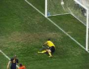 netherlands goalkeeper maarten stekelenburg (r) fails to stop the shot by spain midfielder andrés iniesta (l). 