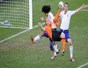 dirk kuyt attempts a scissor kick against japan