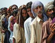 flood victims queue for aid in sanawan, punjab province, pakistan.