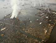 an aerial view shows tsunami damage and flooding in natori city.