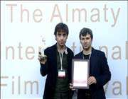  “raw, cooked, burned” director shahram mokri (l) and “askoo” director mohammad-ali hashemzehi (r) hold their prizes at the closing ceremony of the shaken stars film festival in almaty 