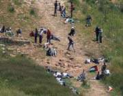 pro-palestinians protesters take cover from israeli forces shooting near the village of majdal shams in the israeli-occupied golan heights.