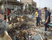 iraqis gather at the scene of a car bomb explosion in the north baghdad district of sadr city on may 22, 2011.