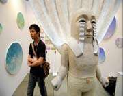 a man walks past an artwork from japanese artist takashi yamauchi at the art fair tokyo 2011 in tokyo.