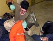 this file photo shows charles graner while abusing a detainee.
