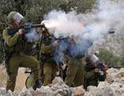 israeli soldiers firing tear gas at palestinian demonstrators. 