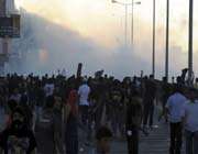 a cloud of tear gas fired by riot-police is seen after a rally in sitra, south of manama. 