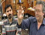 kamyar saeedi (l) pictured with sfu physicist mike thewalt showing a sample of highly enriched silicon