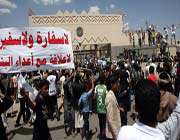 yemenis hold a poster reading in arabic no embassy and no ambassador.. no relations with enemies... outside the gate of the us embassy in sana’a