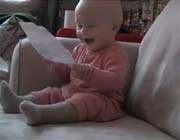 baby laughing hysterically at ripping paper
