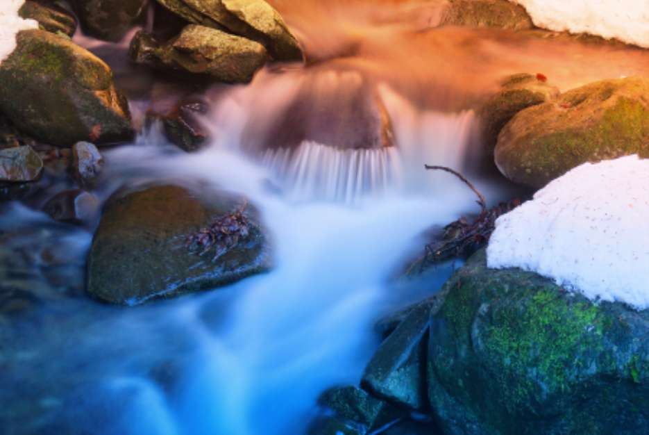 soft water of the stream on the rocks