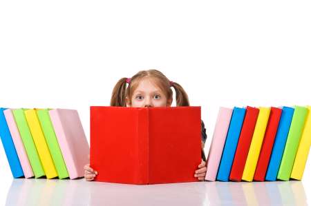 Little girl peeking from pile of books. Isolated