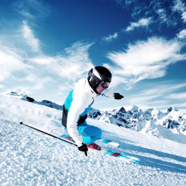 Skier in mountains, prepared piste