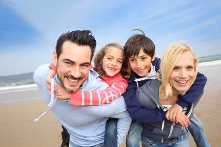 Portrait of cheerful family at the beach