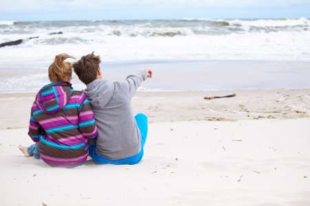happy pair of male and female embracing and having fun wearing w