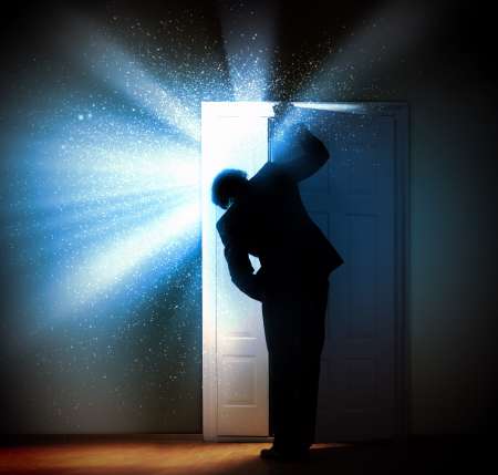 Young businessman opening door