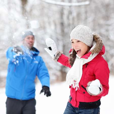 Winter fun - couple in snowball fight