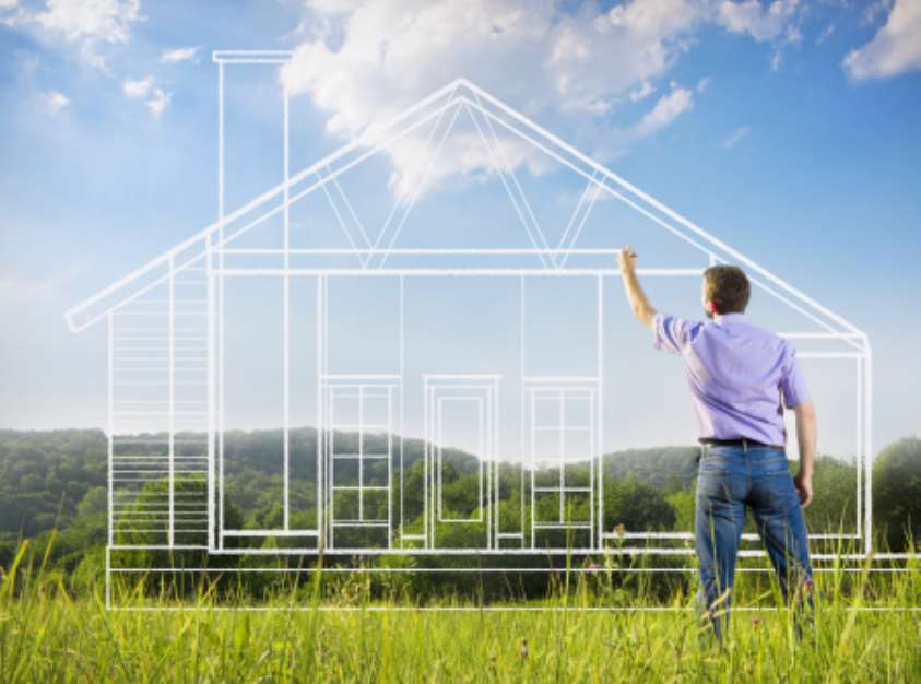 Man drawing a house blueprint in nature