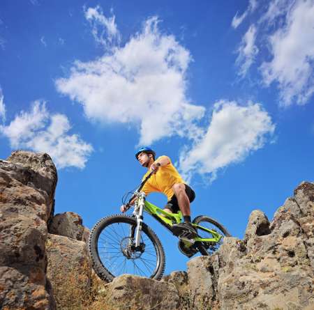 A person riding a mountain bike on a sunny day