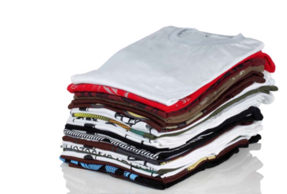 Row of colorful cotton t-shirts. Clothes background.