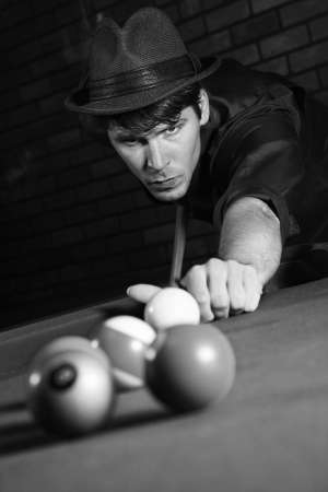 retro male shooting pool.