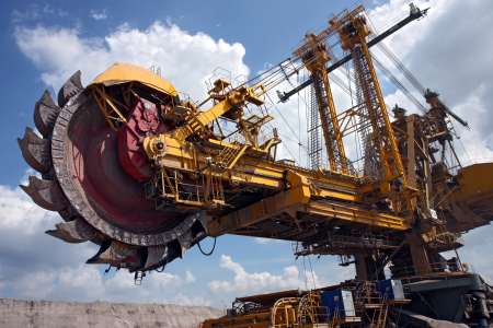 huge coal mining coal machine under cloudy sky