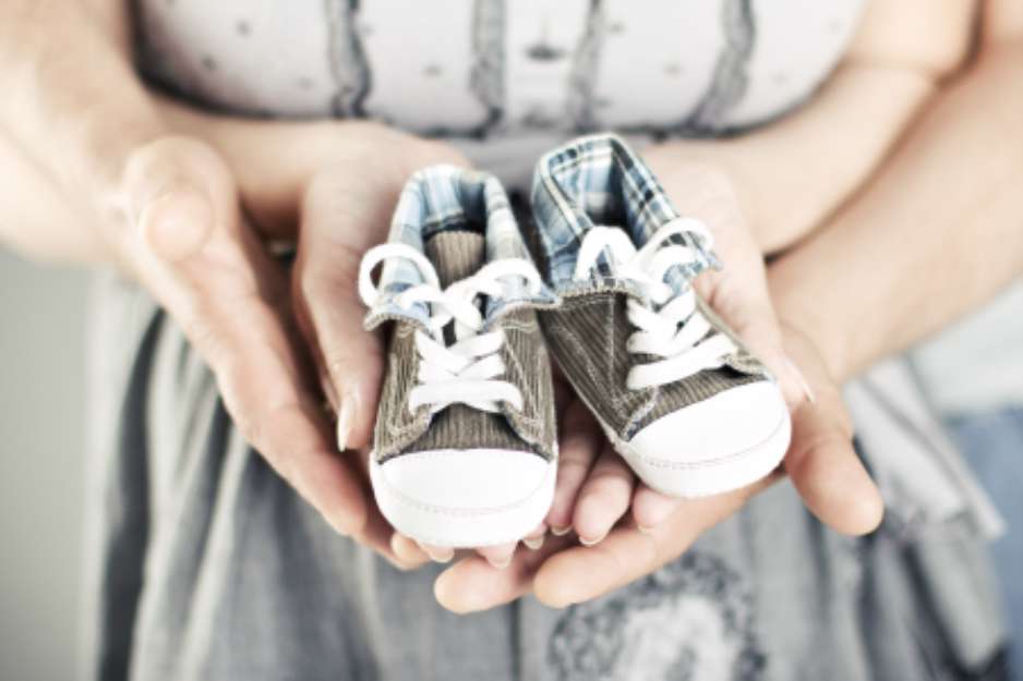 Newborn baby booties in parents hands