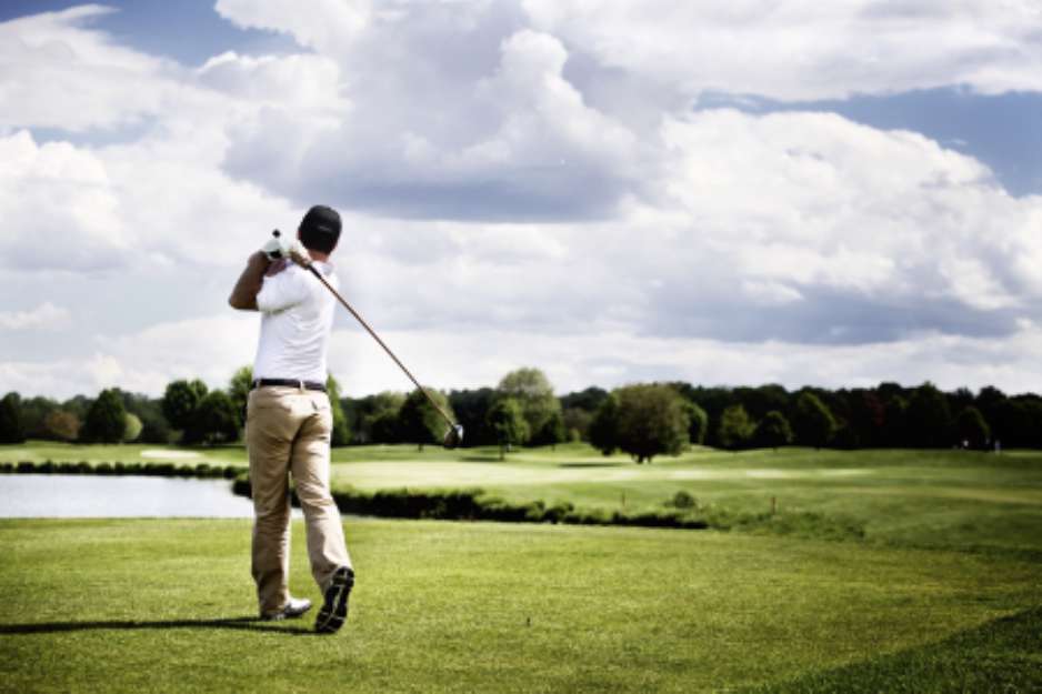 Golf player teeing off