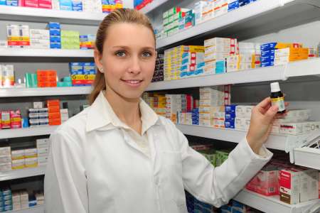 attractive pharmacist selling medicine