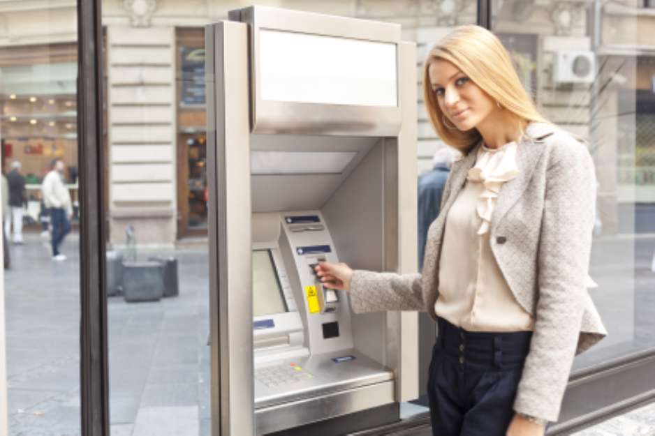 Woman using Bank ATM machine