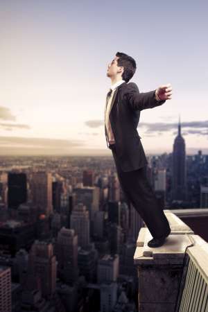 businessman standing on top of a building in NY city