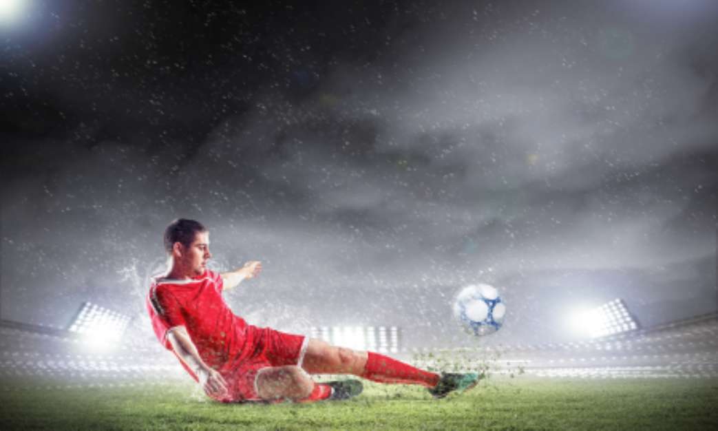 football player striking the ball