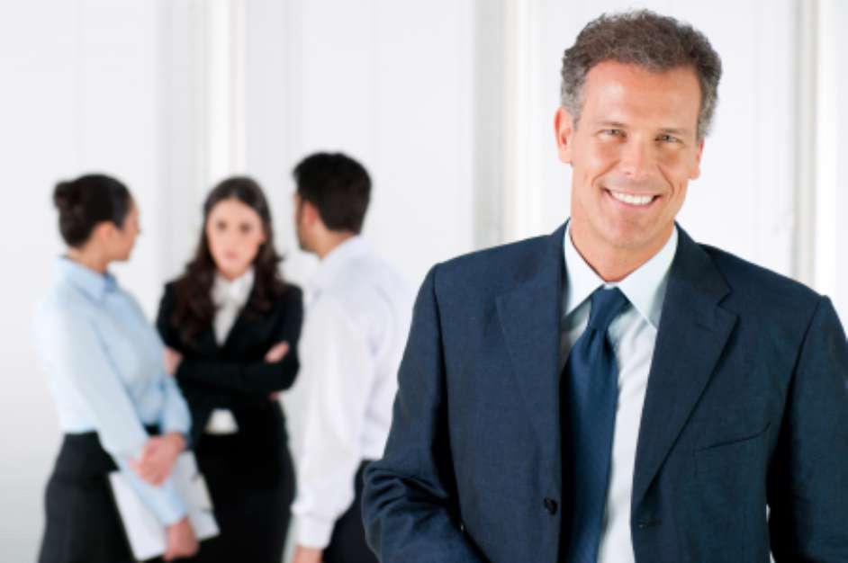 Happy smiling business man with colleagues