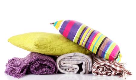 Plaids and color pillows, isolated on white