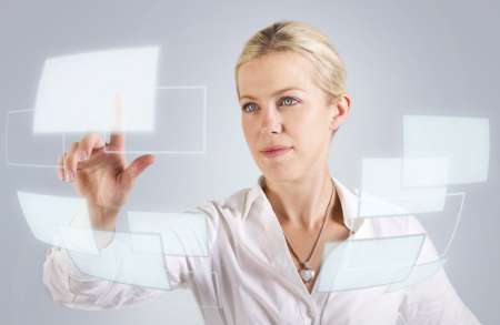Beautiful woman touching a digital screen, panel, hologram