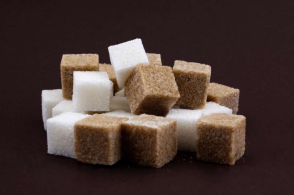 bunch of brown and white lump sugar on a brown background