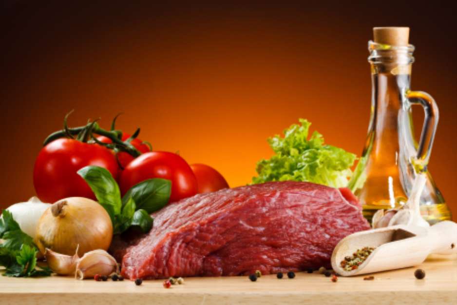 Raw beef on cutting board and vegetables