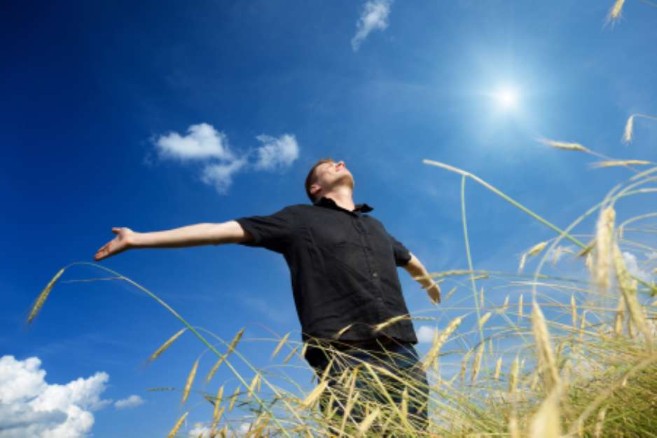 happy young man rest on wheat field