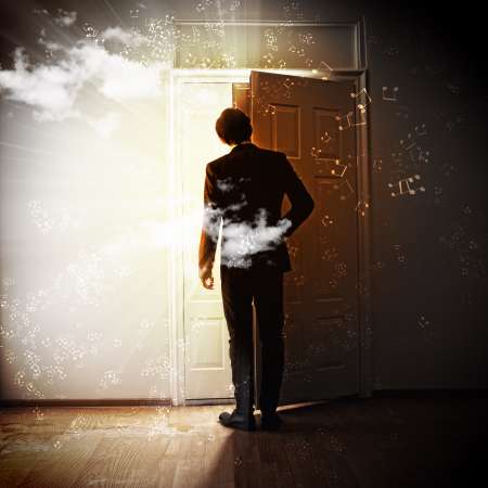 Young businessman opening door