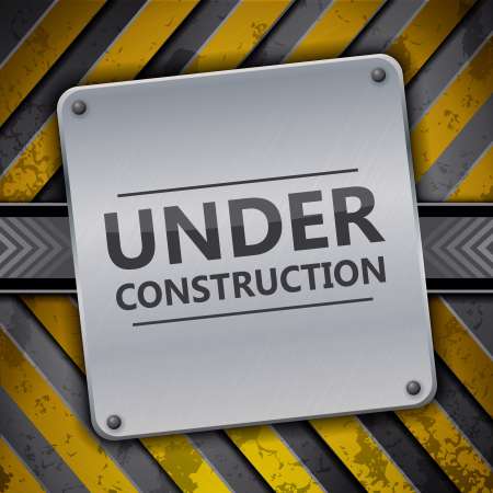 Under construction metal sign on metallic warning stripes