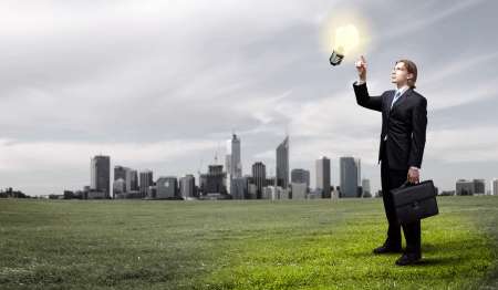 Businessman holding light bulb