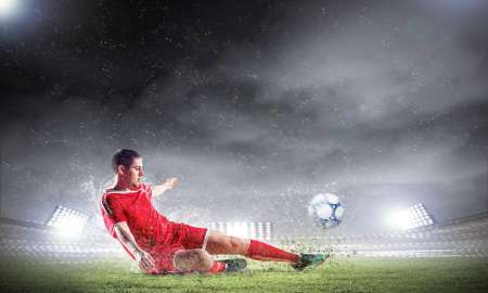 football player striking the ball