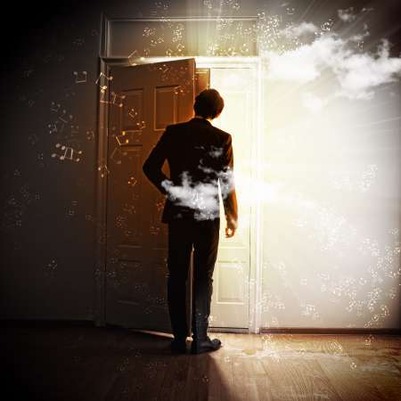 Young businessman opening door