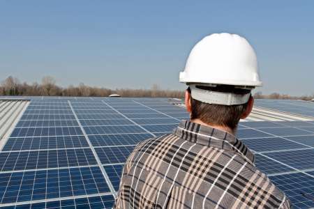 Worker looking at a photovoltaic plant