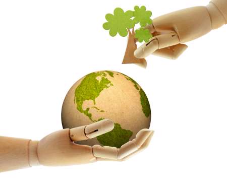 wooden hand help growing tree on earth together