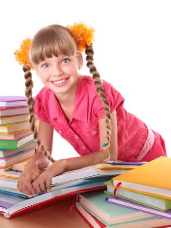 Child reading open  book on table.